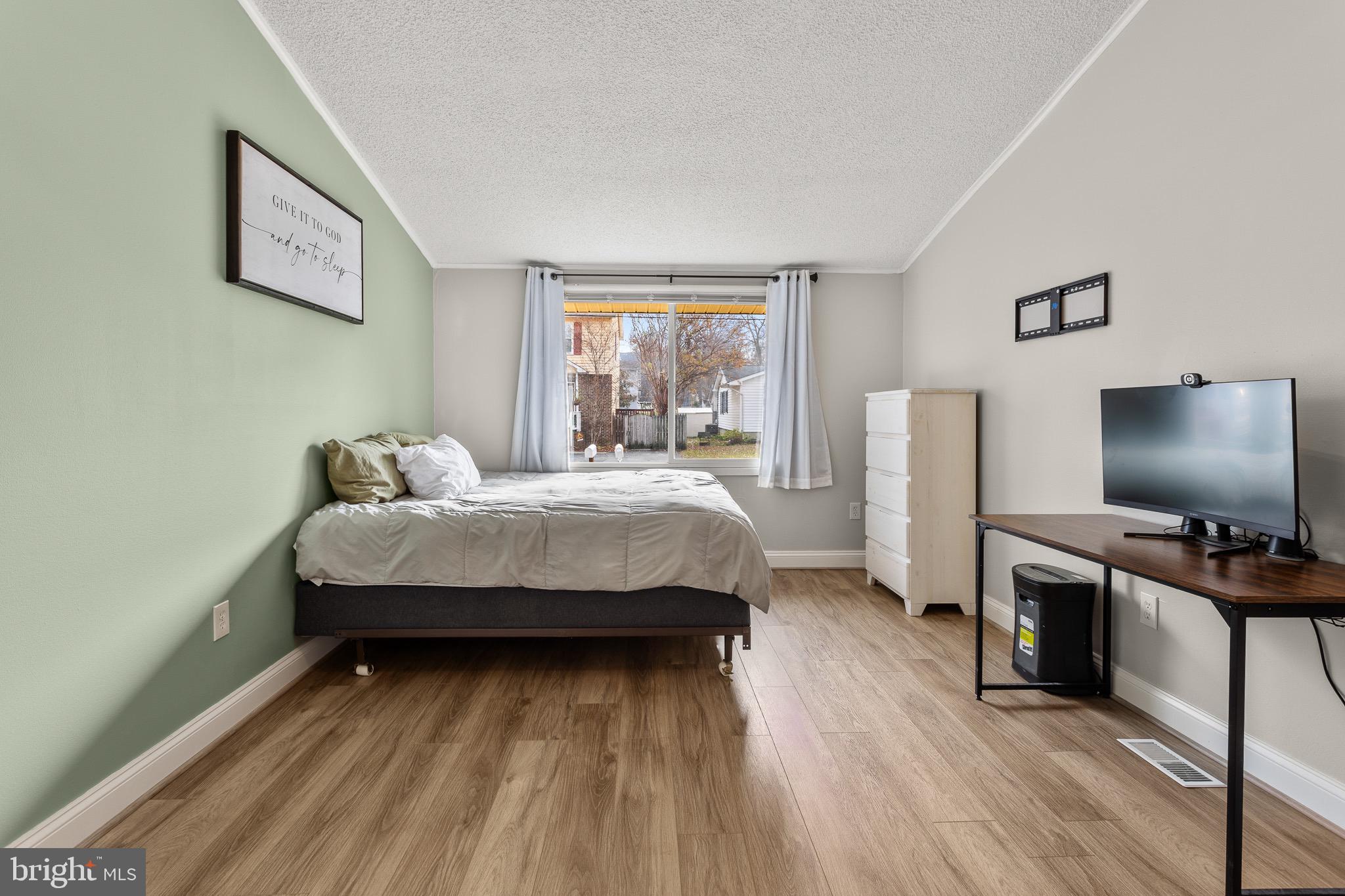 4912 Beech Street Shady Side, MD 20764 - Photo 12 of 42 a bedroom with a bed and a flat screen tv