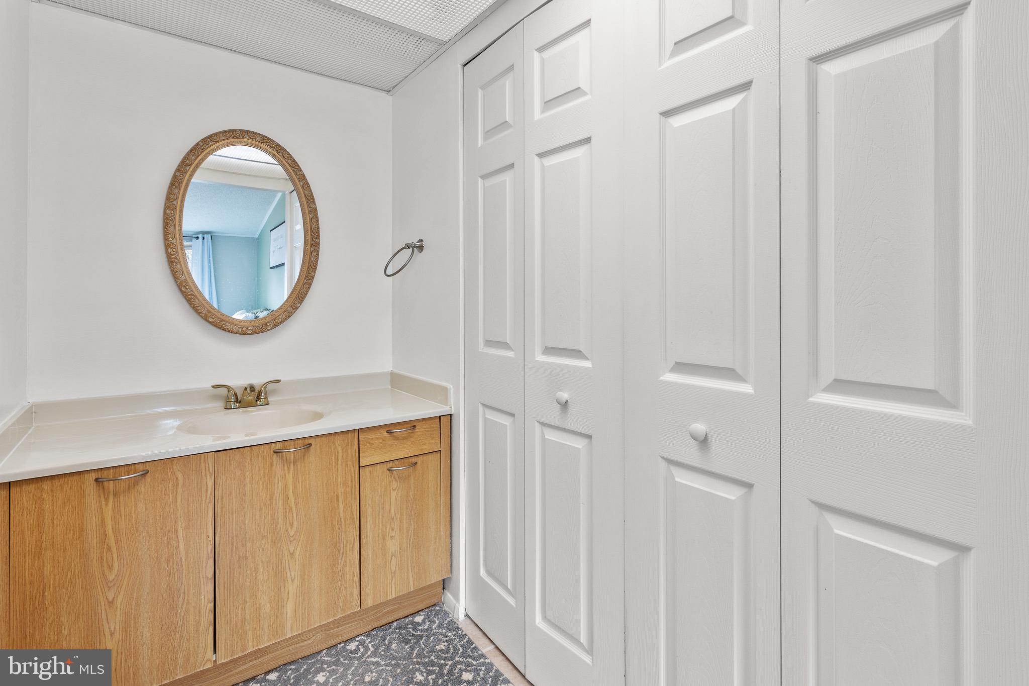 4912 Beech Street Shady Side, MD 20764 - Photo 13 of 42 a bathroom with a sink and a mirror