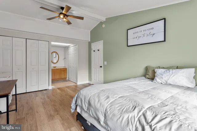 a bedroom with a large bed and a chandelier