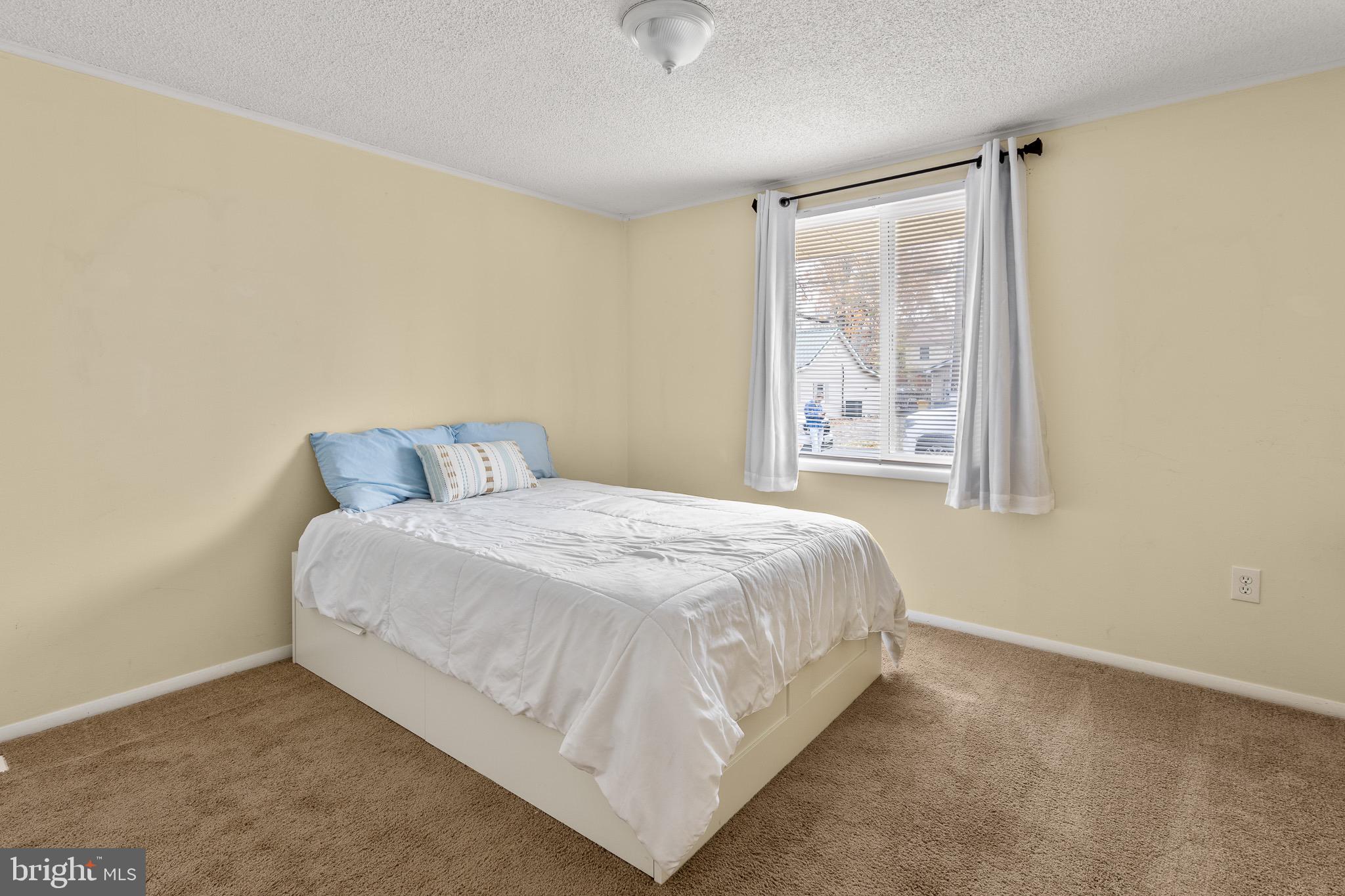 4912 Beech Street Shady Side, MD 20764 - Photo 16 of 42 a bedroom with a bed and window