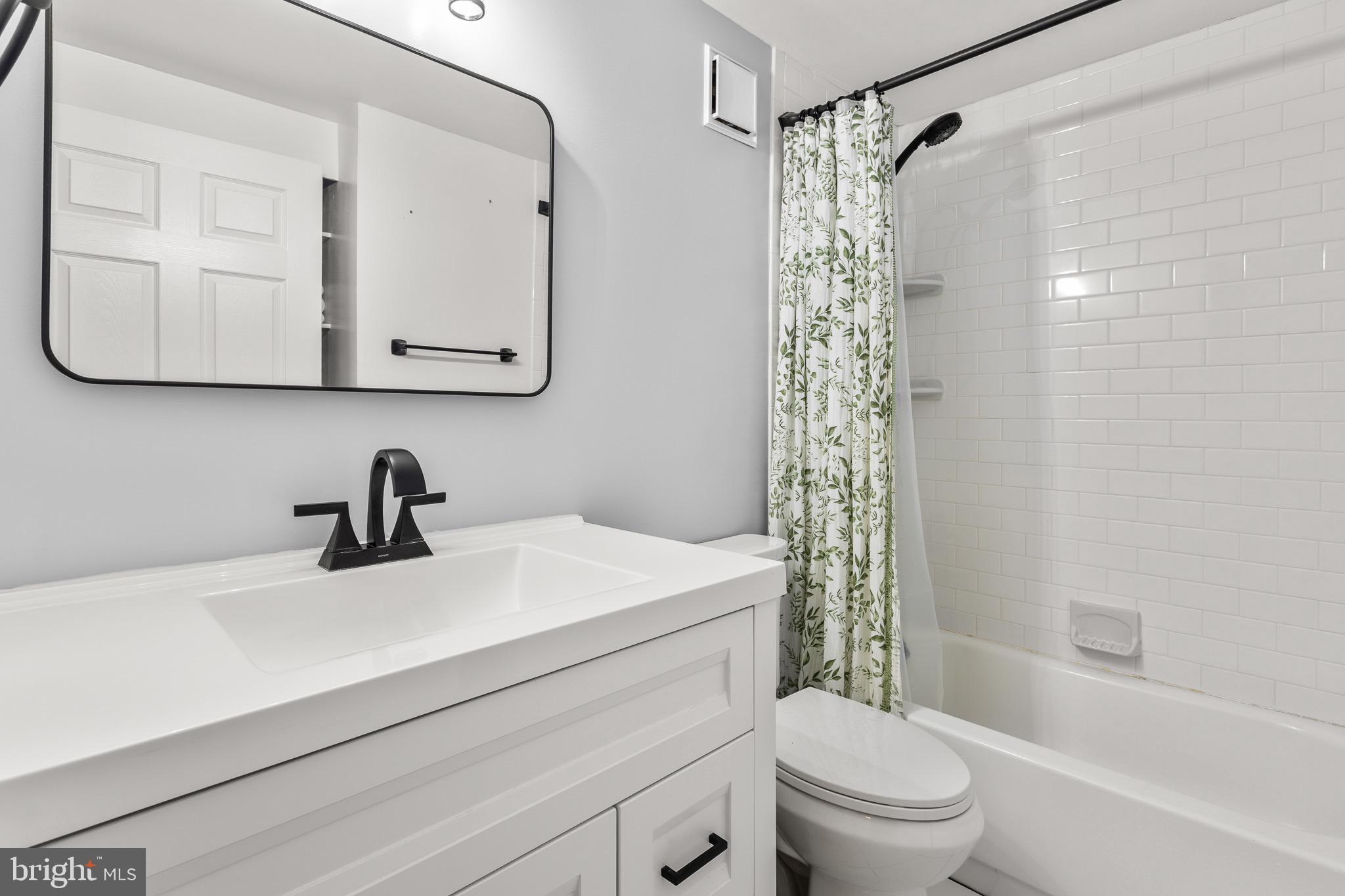 4912 Beech Street Shady Side, MD 20764 - Photo 17 of 42 a bathroom with a sink a toilet and shower