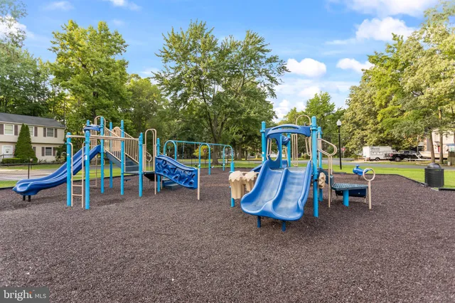 a view of outdoor space with playground and green space