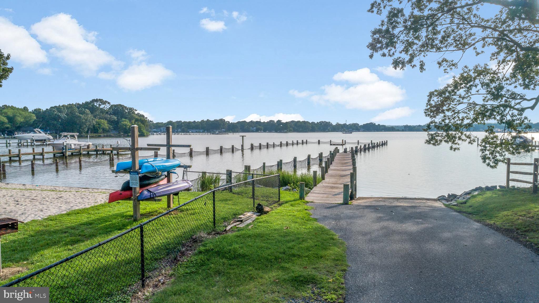 4912 Beech Street Shady Side, MD 20764 - Photo 35 of 42 a view of a lake with couches and wooden fence