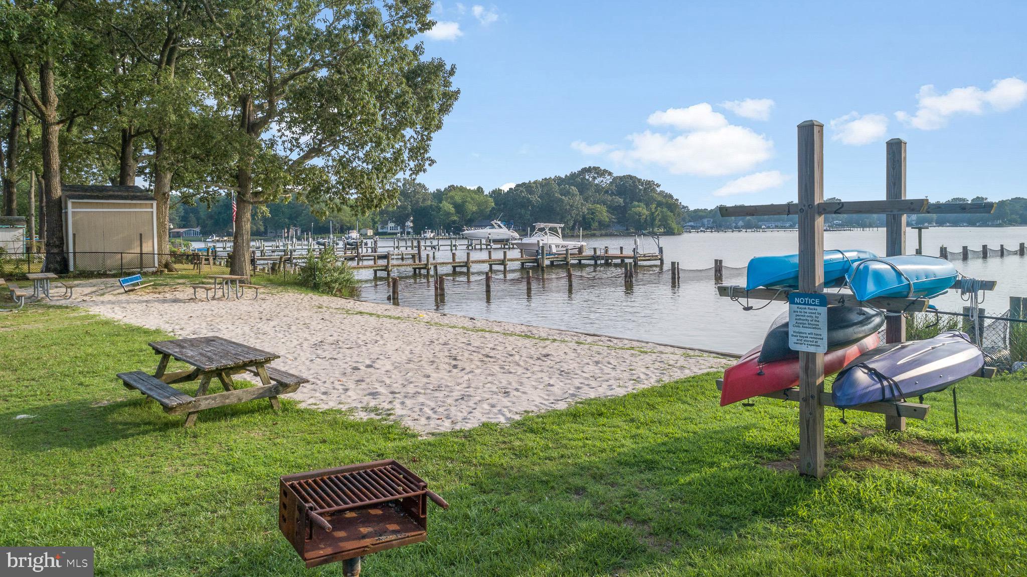 4912 Beech Street Shady Side, MD 20764 - Photo 36 of 42 a view of a lake with a bench and lake view
