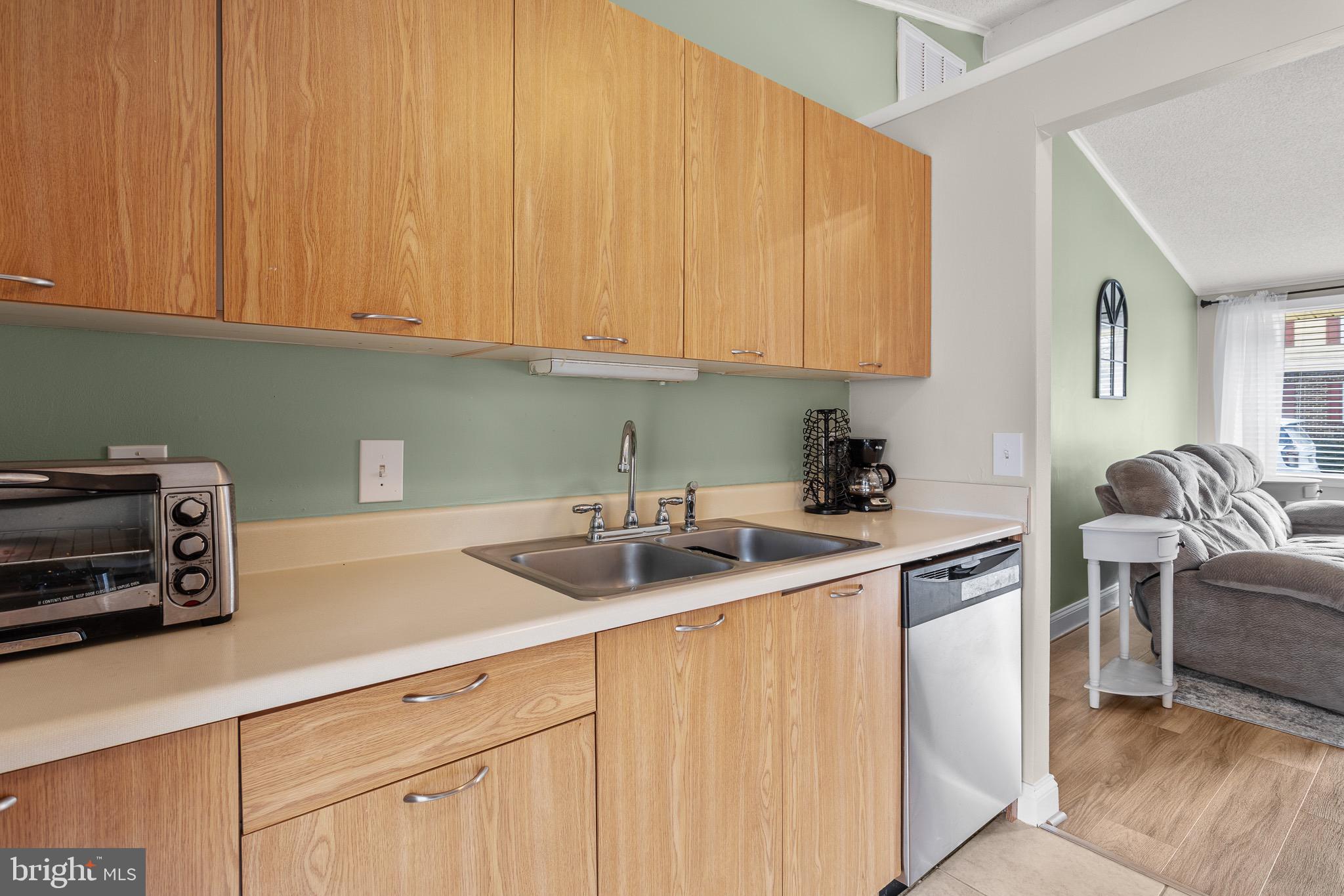 4912 Beech Street Shady Side, MD 20764 - Photo 4 of 42 a kitchen with appliances a sink and cabinets