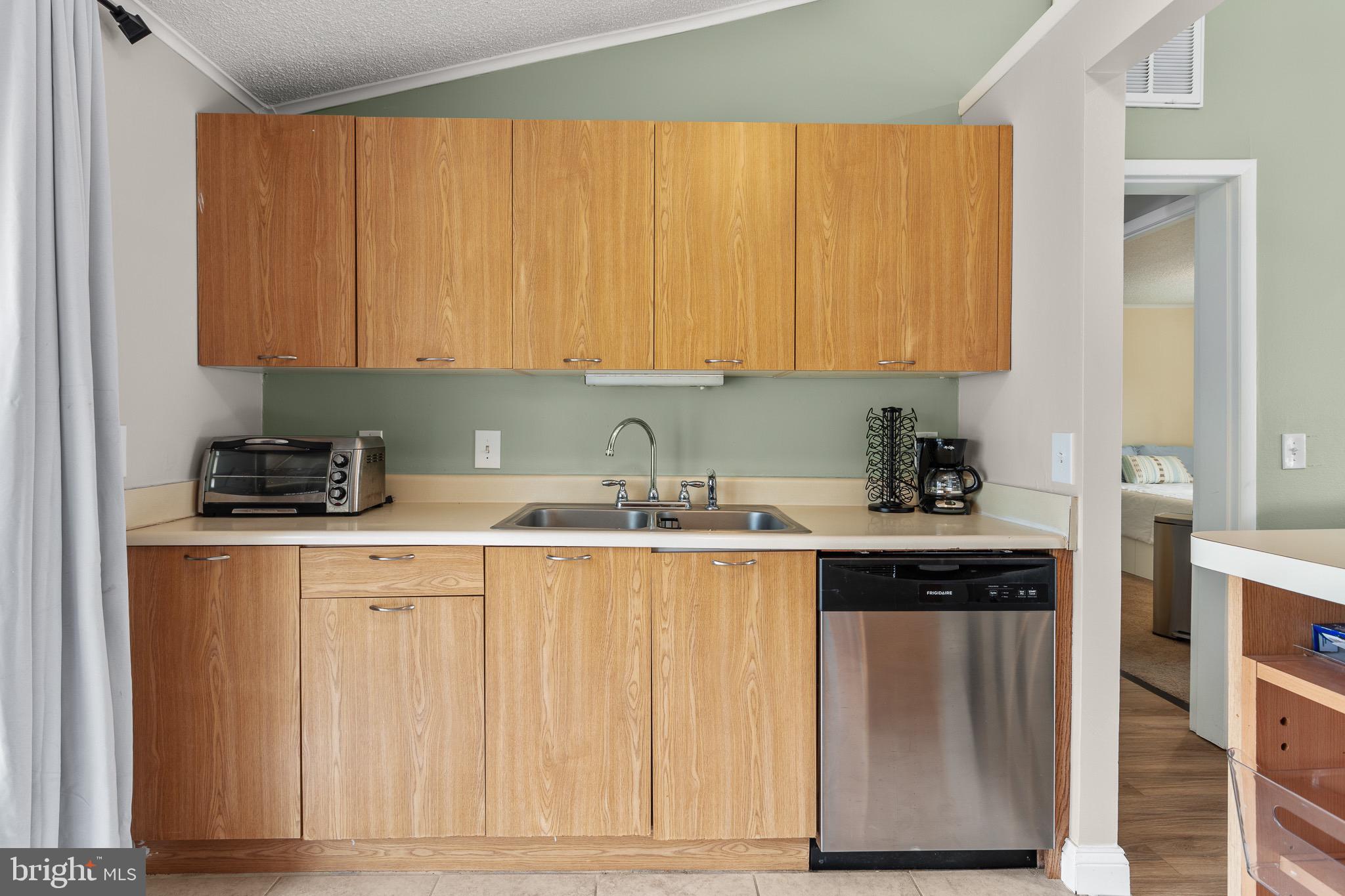 4912 Beech Street Shady Side, MD 20764 - Photo 5 of 42 a kitchen with stainless steel appliances granite countertop a stove a sink and a white refrigerator
