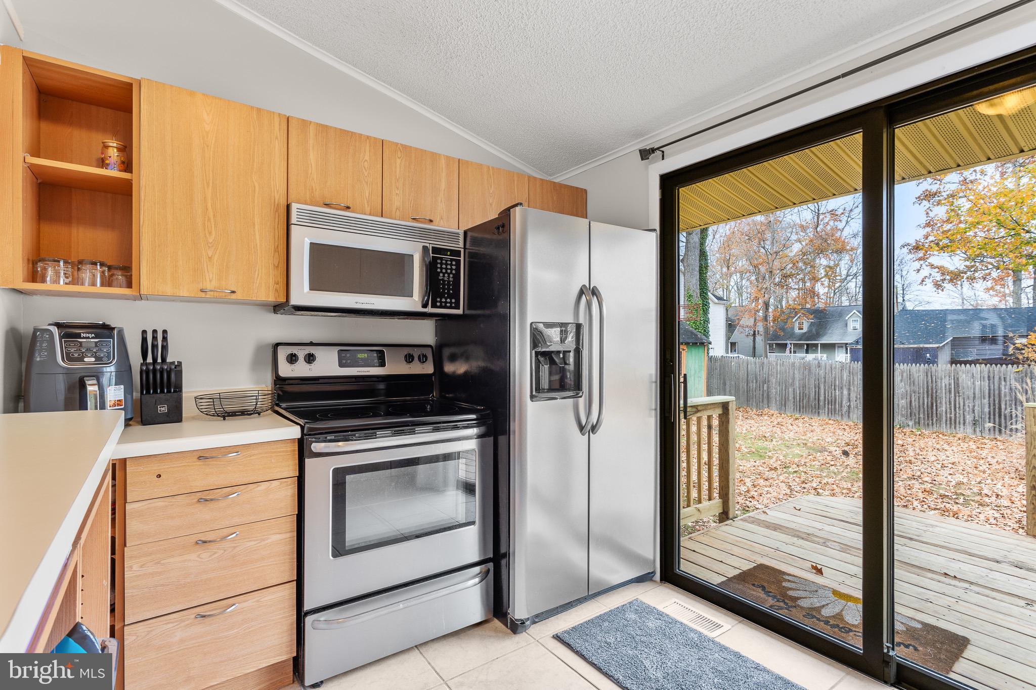 4912 Beech Street Shady Side, MD 20764 - Photo 7 of 42 a kitchen with stainless steel appliances a stove a refrigerator and a sink