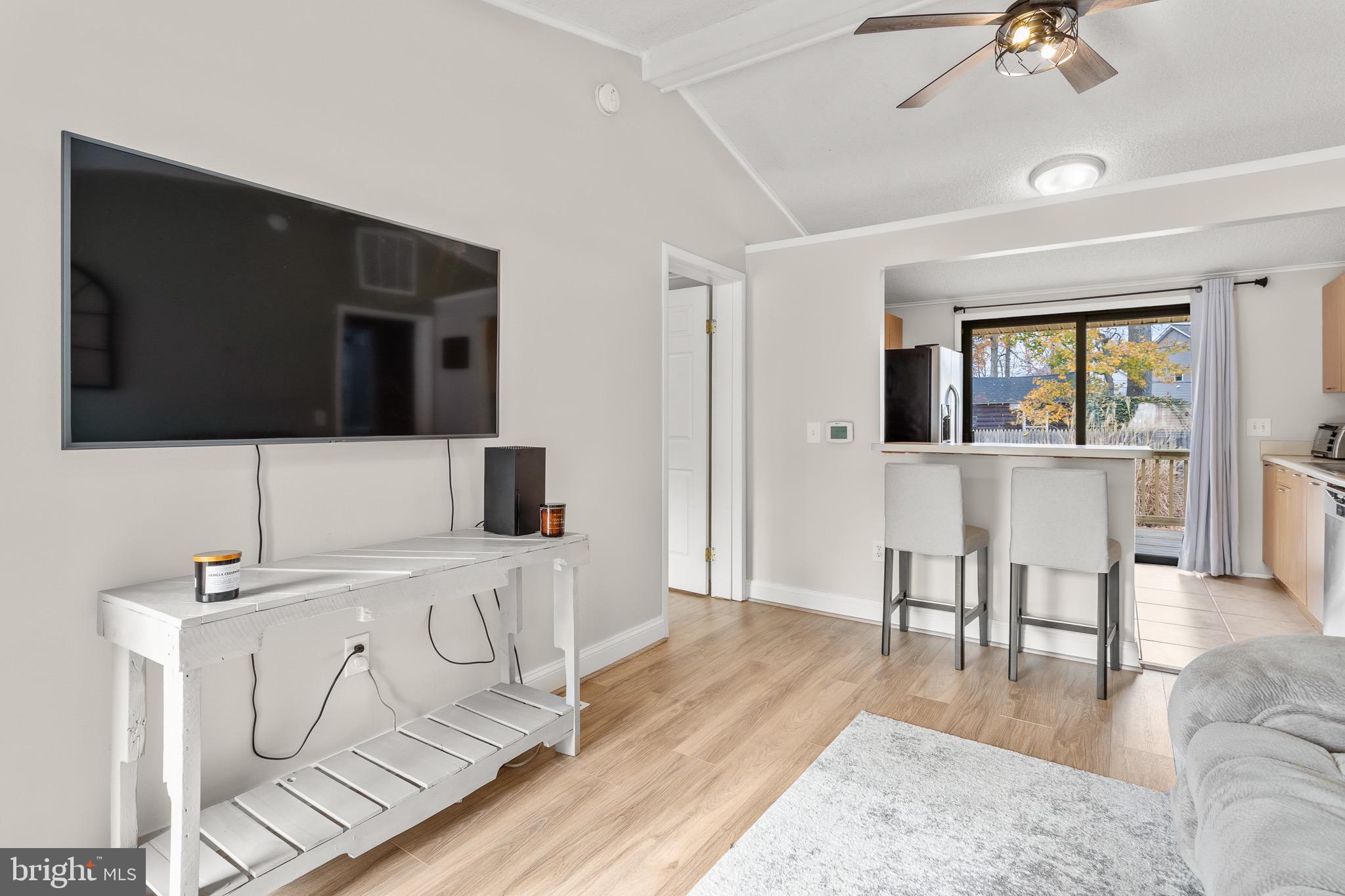 4912 Beech Street Shady Side, MD 20764 - Photo 10 of 42 a living room with furniture and a flat screen tv