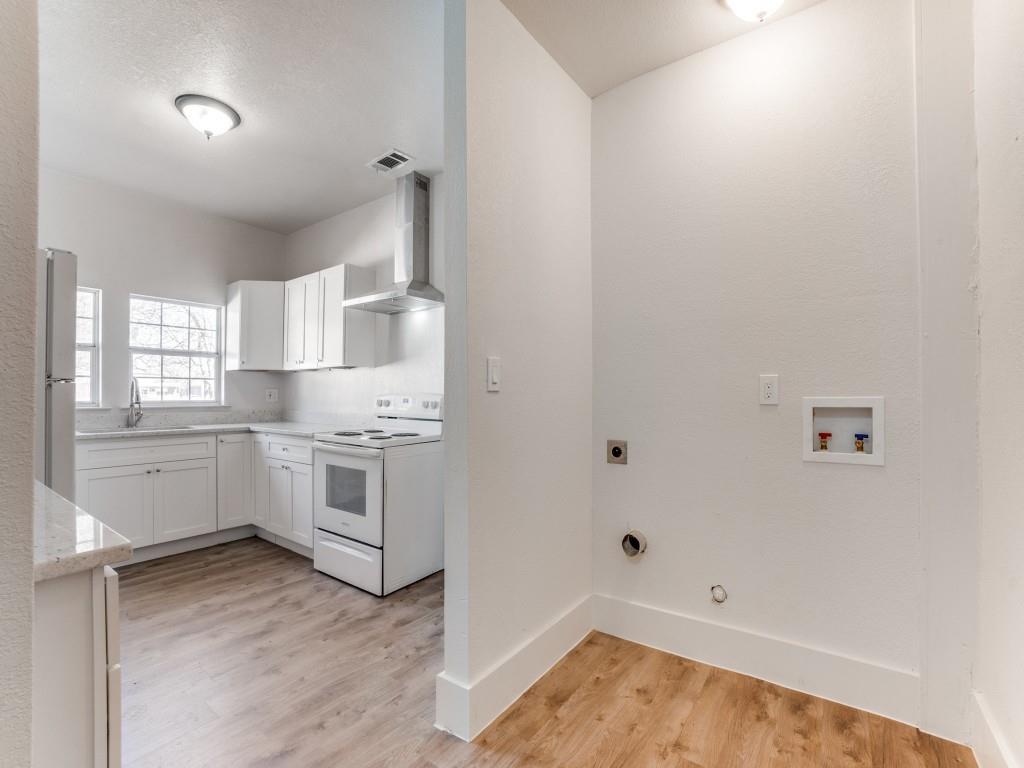 1628 Poplar Street Dallas, TX 75215 - Photo 11 of 20 a kitchen with white cabinets and white appliances