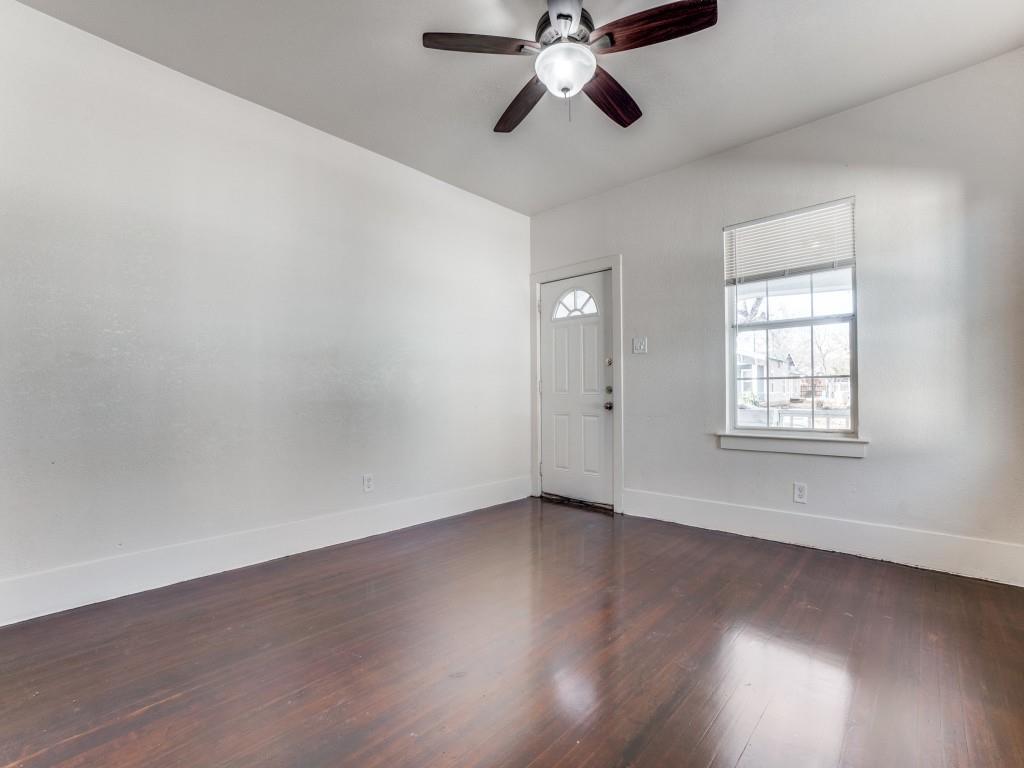 1628 Poplar Street Dallas, TX 75215 - Photo 12 of 20 an empty room with wooden floor fan and windows