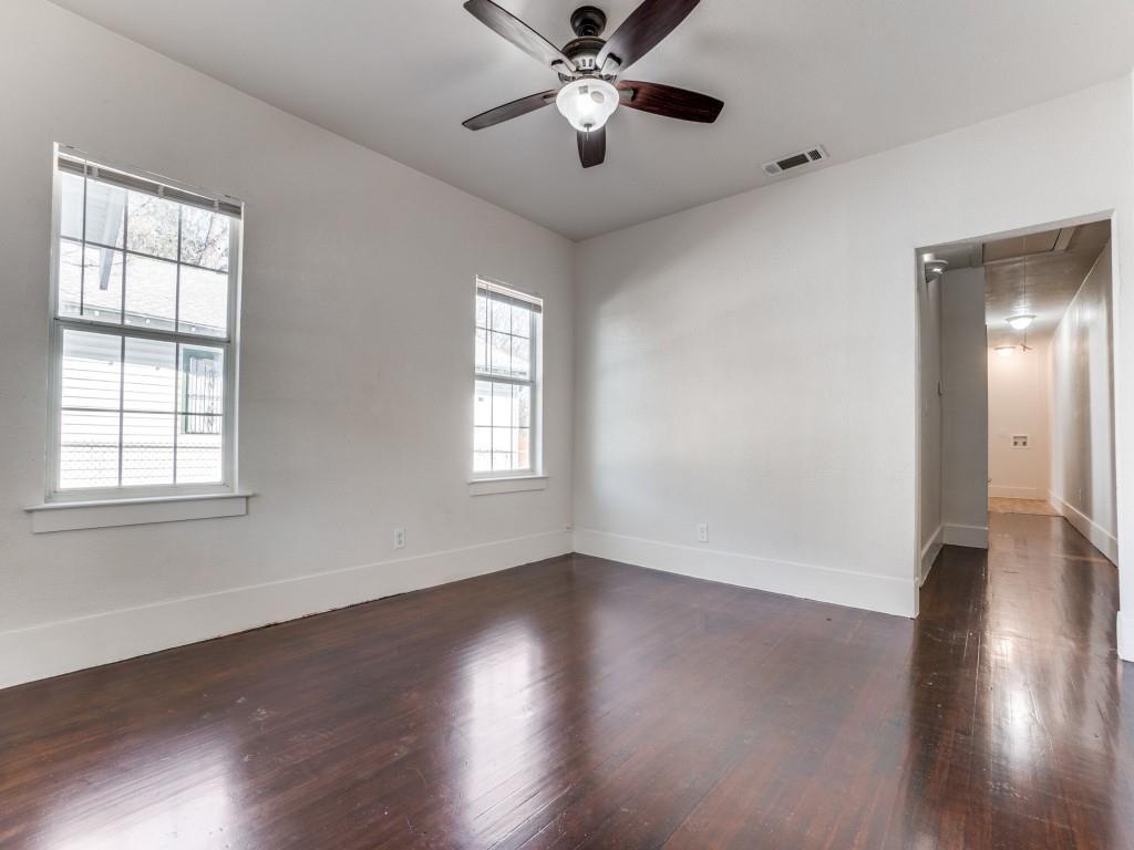 1628 Poplar Street Dallas, TX 75215 - Photo 13 of 20 a view of an empty room with wooden floor and a window