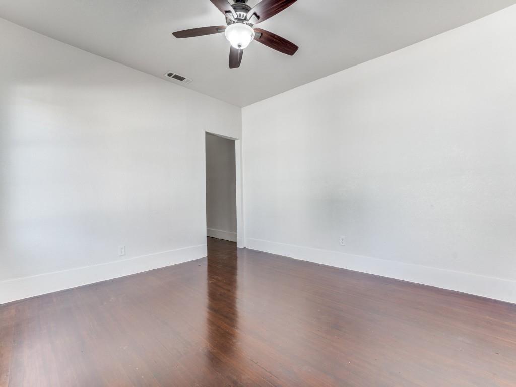 1628 Poplar Street Dallas, TX 75215 - Photo 14 of 20 an empty room with wooden floor fan and windows