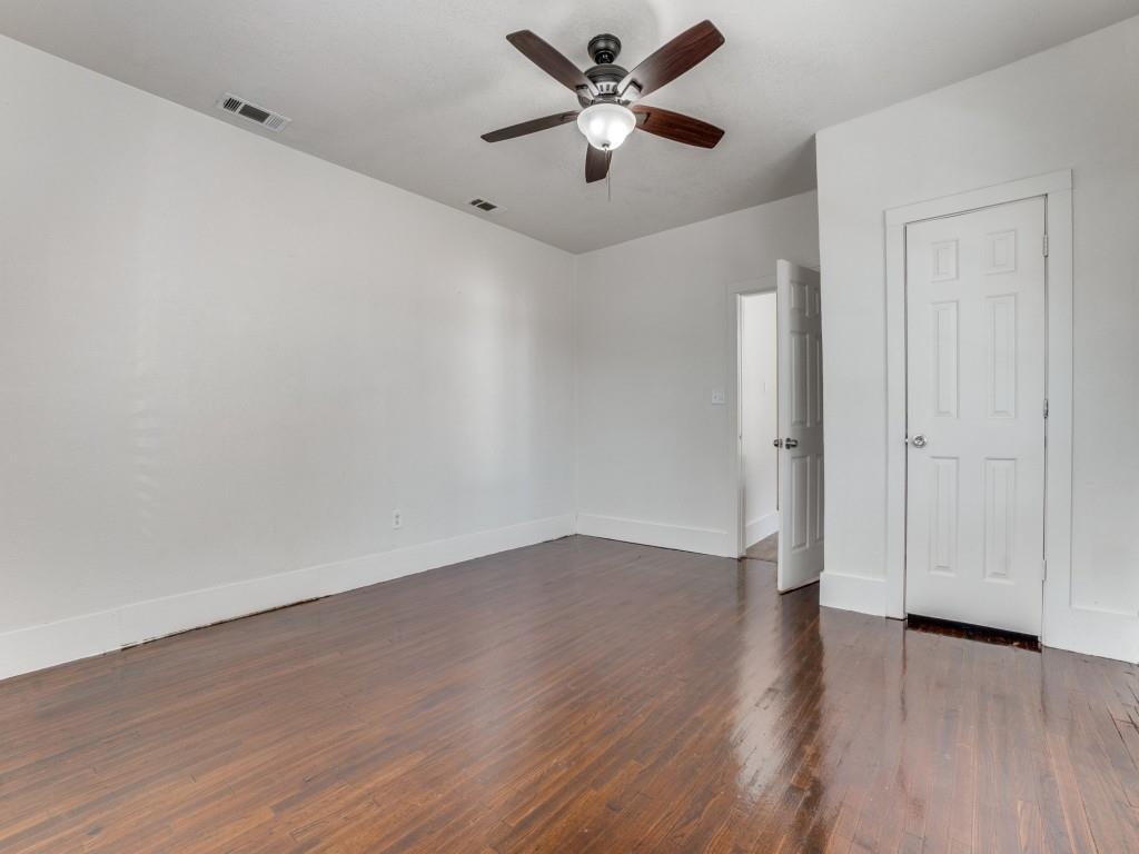 1628 Poplar Street Dallas, TX 75215 - Photo 17 of 20 an empty room with wooden floor and a ceiling fan