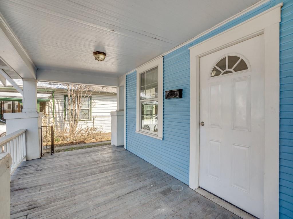 1628 Poplar Street Dallas, TX 75215 - Photo 2 of 20 a view of an empty room with wooden floor and a window