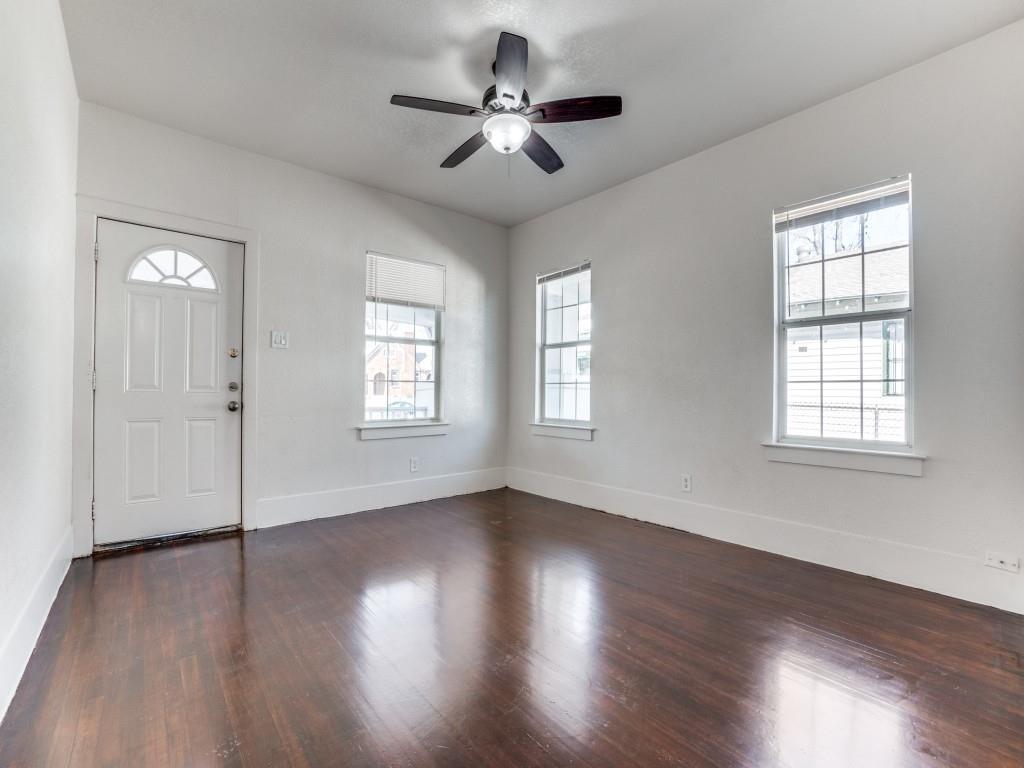 1628 Poplar Street Dallas, TX 75215 - Photo 3 of 20 a view of an empty room with wooden floor and a window