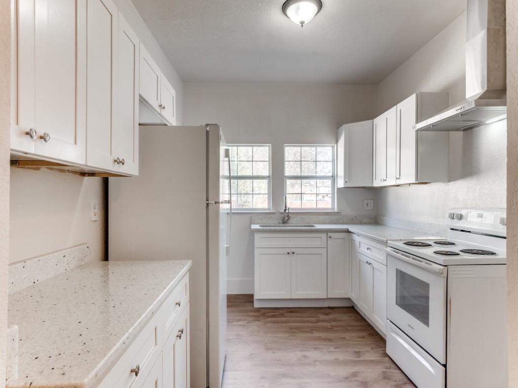 1628 Poplar Street Dallas, TX 75215 - Photo 4 of 20 a kitchen with stainless steel appliances granite countertop a sink stove and refrigerator