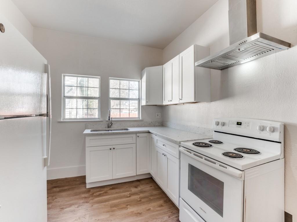 1628 Poplar Street Dallas, TX 75215 - Photo 5 of 20 a kitchen with a stove a sink and a microwave