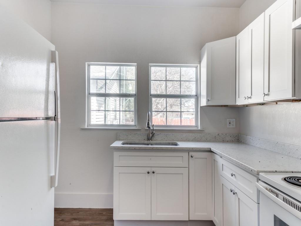 1628 Poplar Street Dallas, TX 75215 - Photo 7 of 20 a kitchen with granite countertop white cabinets and a sink
