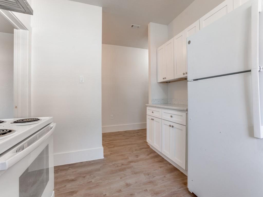 1628 Poplar Street Dallas, TX 75215 - Photo 10 of 20 a kitchen with white cabinets and white appliances