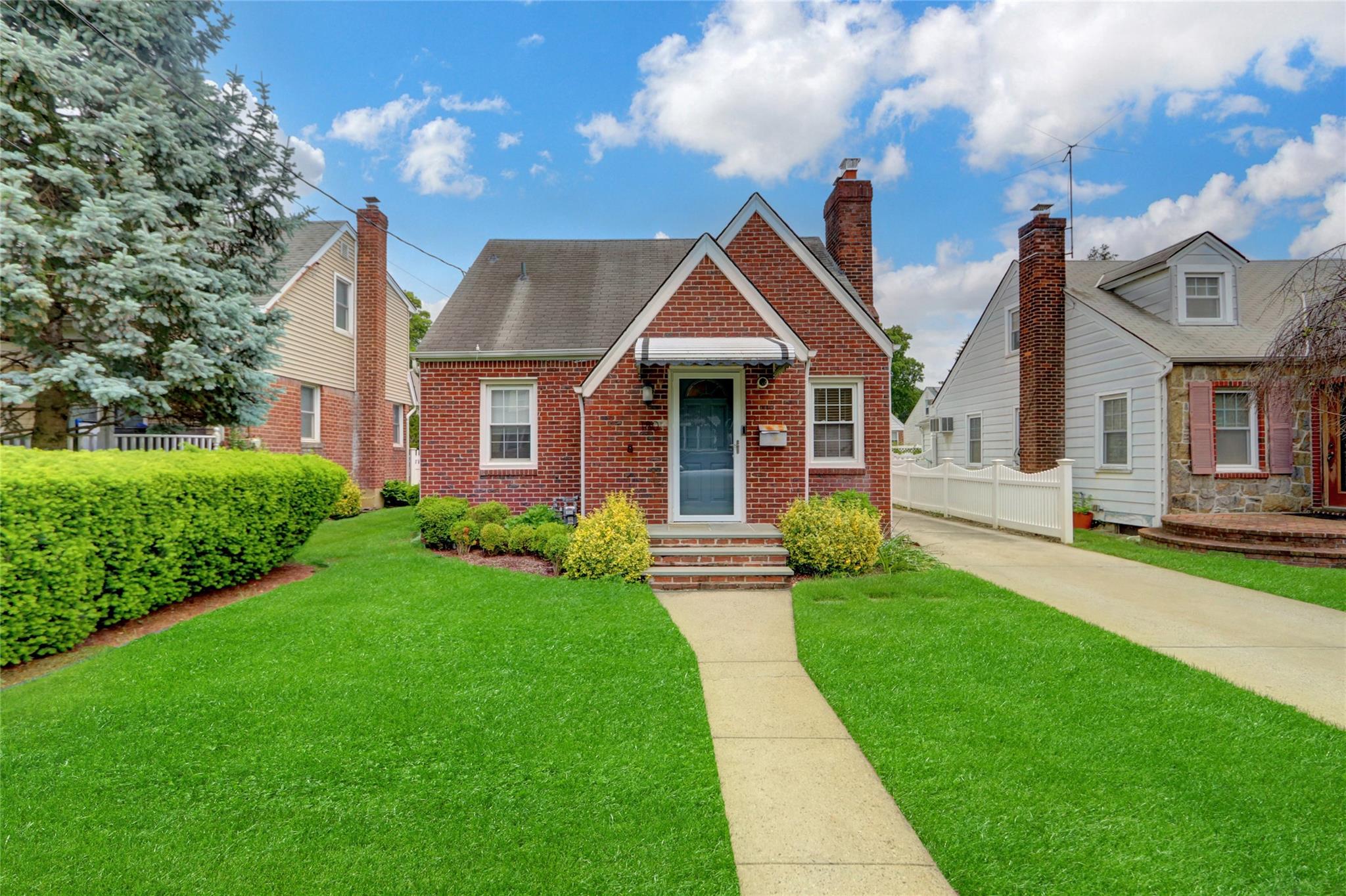 180 Beebe Road Mineola, NY 11501 - Photo 1 of 1 Bungalow featuring brick siding, a shingled roof, a chimney, and concrete driveway