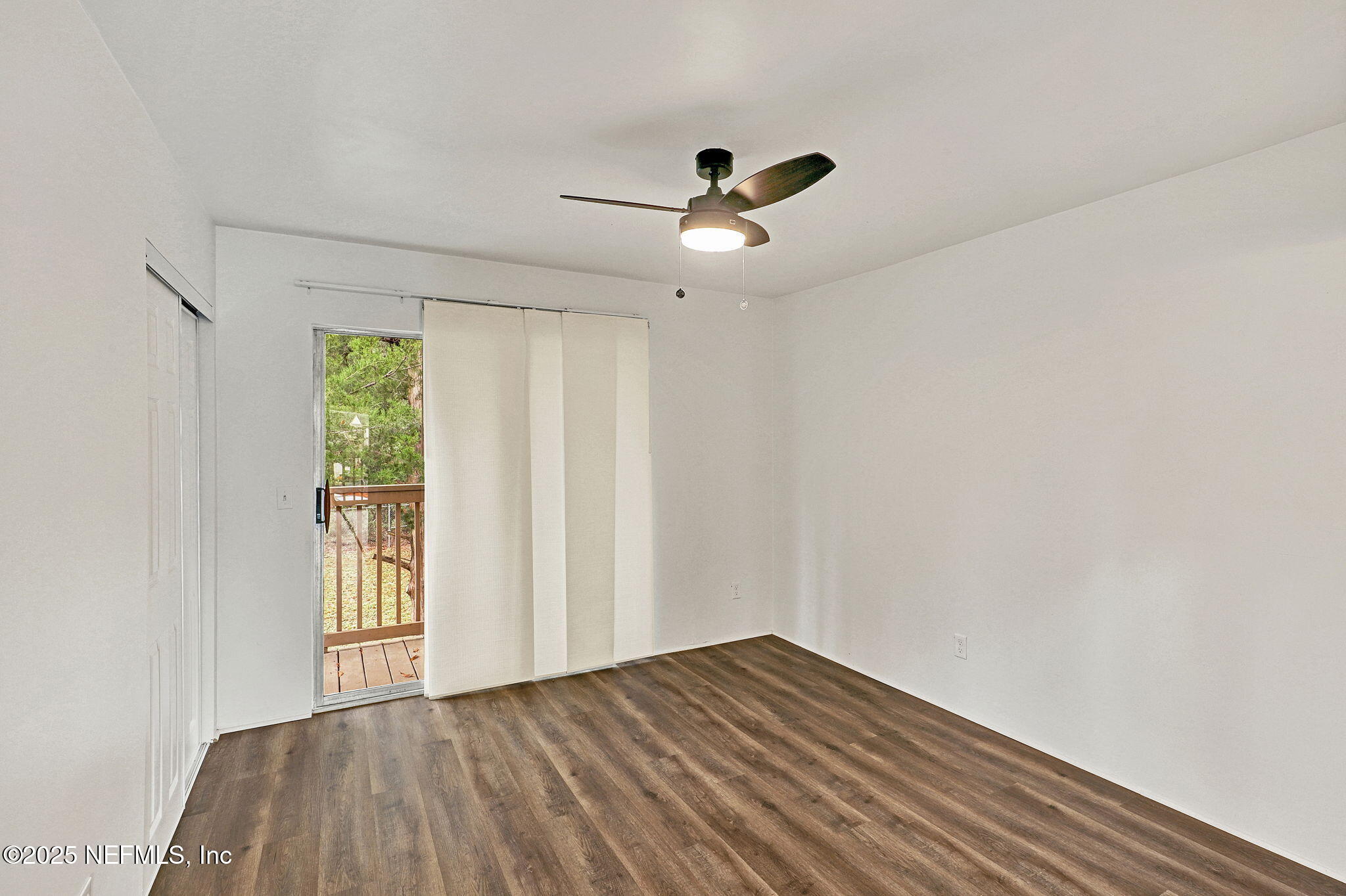 2300 Twelve Oaks Drive, Unit B4 Orange Park, FL 32065 - Photo 13 of 15 a view of empty room with wooden floor and fan