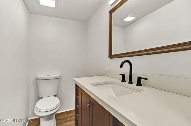 a bathroom with a toilet sink and mirror