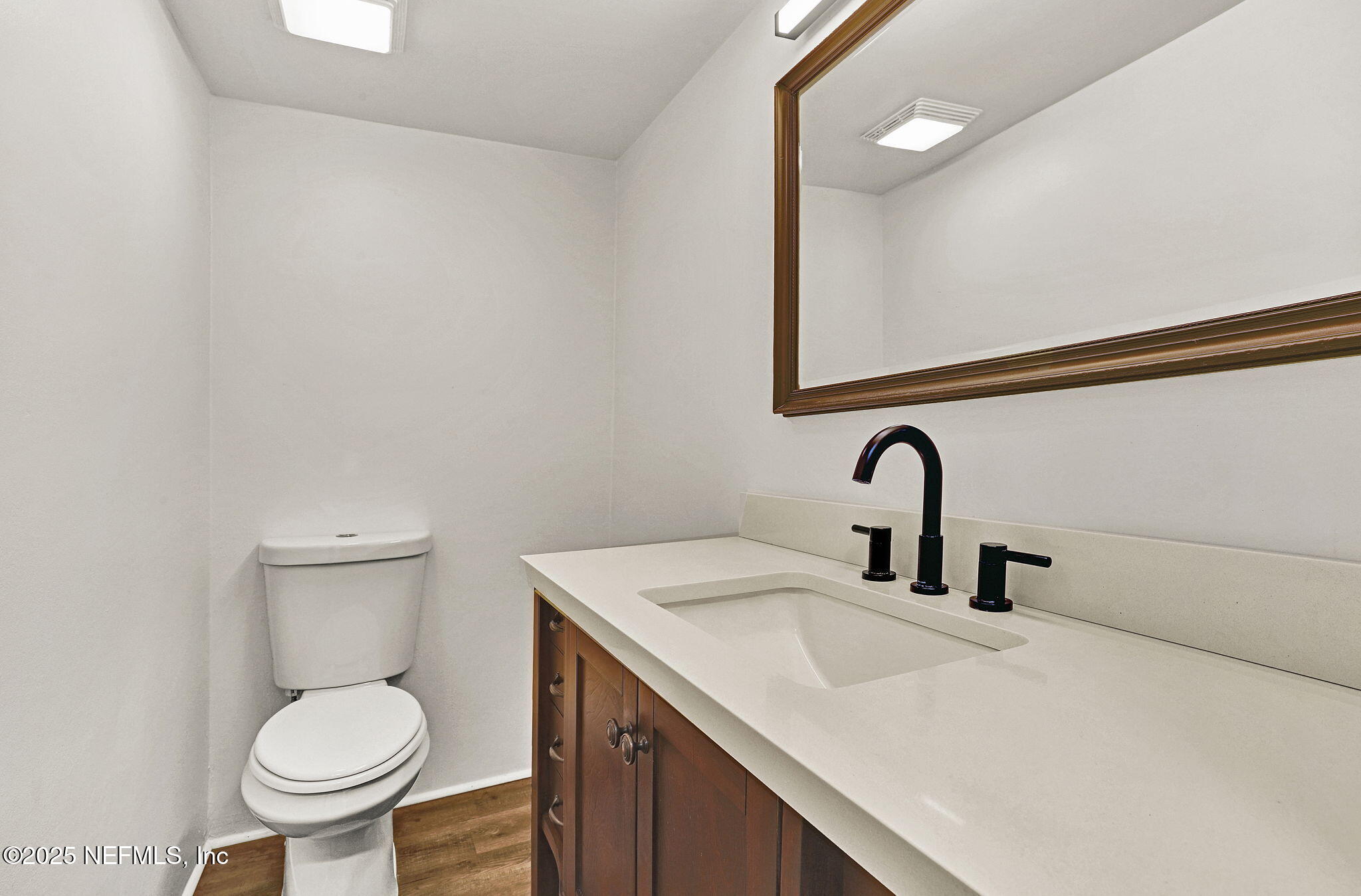 2300 Twelve Oaks Drive, Unit B4 Orange Park, FL 32065 - Photo 14 of 15 a bathroom with a toilet sink and mirror