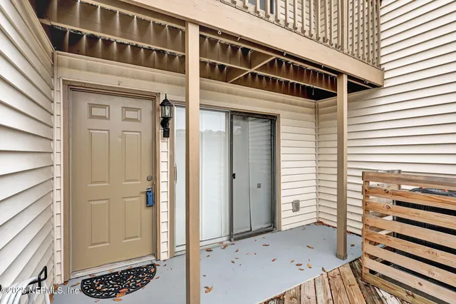 a view of a porch with wooden floor and a cabinet