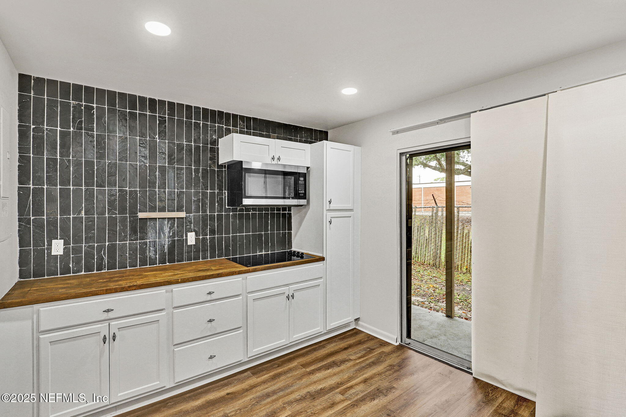 2300 Twelve Oaks Drive, Unit B4 Orange Park, FL 32065 - Photo 5 of 15 a kitchen with white cabinets and sink