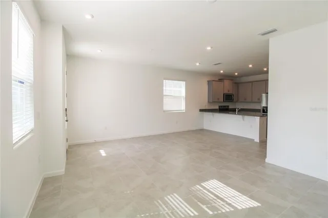 a view of a kitchen with a sink and cabinets