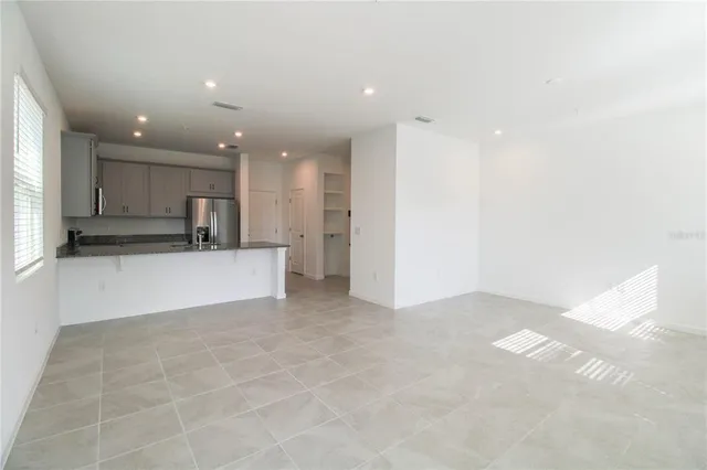 a view of kitchen with kitchen island and stainless steel appliances