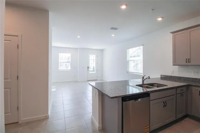 a kitchen that has a sink and cabinets