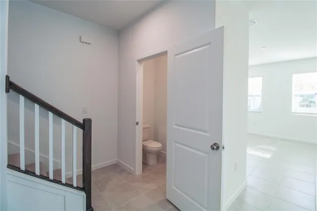 a bathroom with a granite countertop toilet and a sink