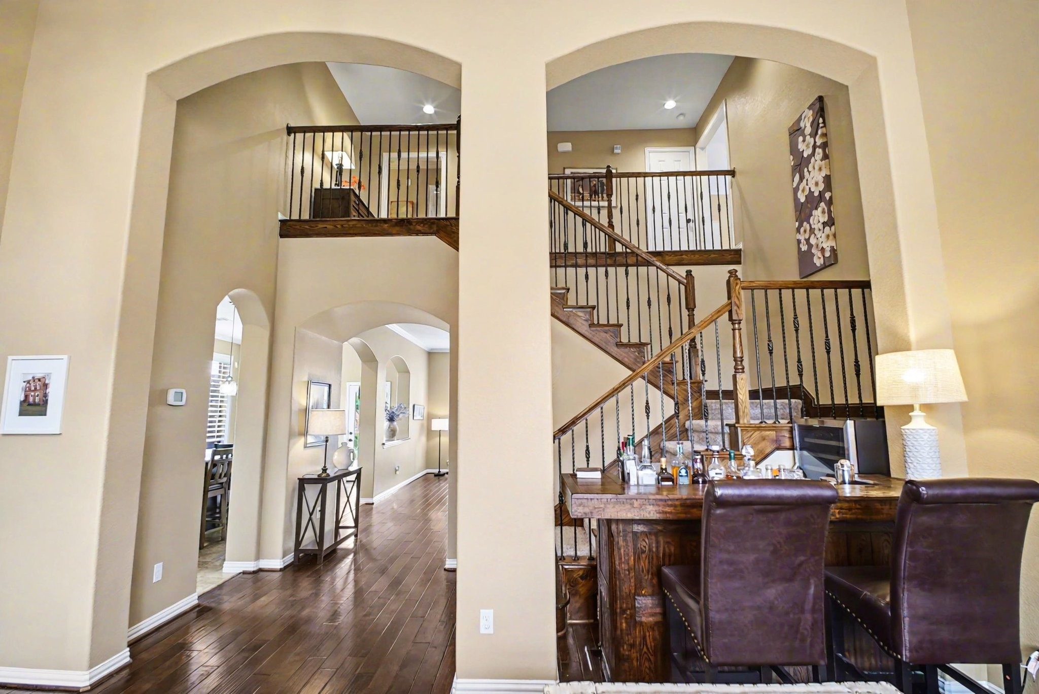 8210 Thunder Ridge Way Missouri City, TX 77459 - Photo 5 of 42 Step into a grand entrance featuring stunning architectural arches, a sweeping staircase to the second level, and impressive high ceilings in the living areas.