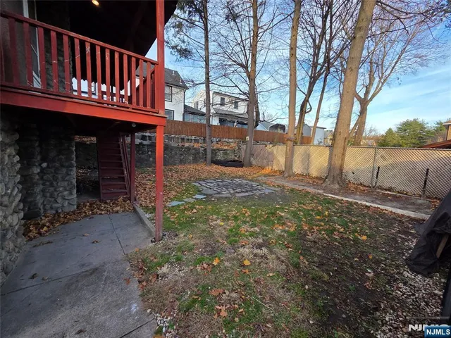 a view of a backyard with a fence