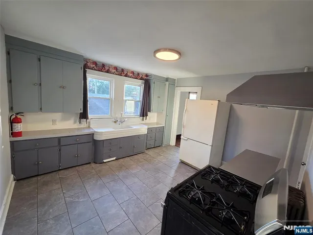 a kitchen with a sink stove and refrigerator