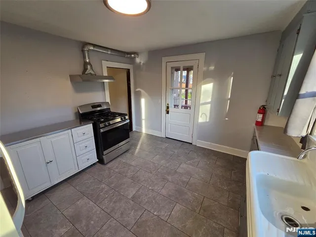 a kitchen with a sink and a stove top oven