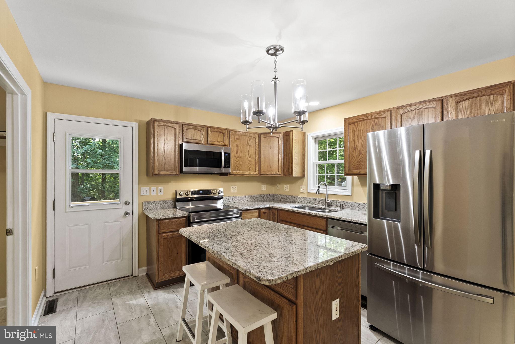 20065 Crooked Run Road Culpeper, VA 22701 - Photo 15 of 62 a kitchen with stainless steel appliances granite countertop a refrigerator and a stove top oven