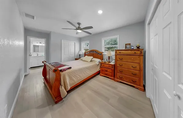 a spacious bedroom with a bed and a chandelier