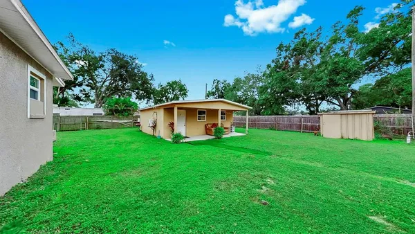 a view of a house with a backyard