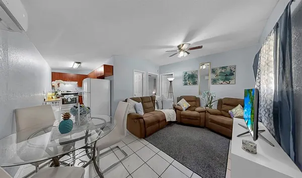a living room with furniture and a chandelier