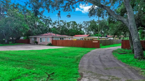 a front view of house with yard and green space