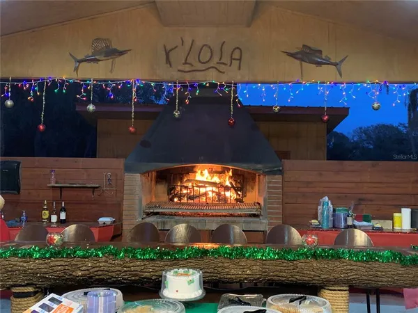 a view of a patio with table and chairs under an umbrella
