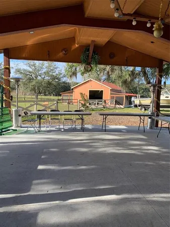 a view of a patio with a table chairs and a backyard