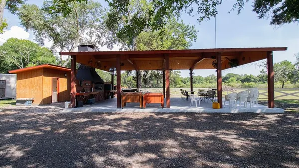 an outdoor sitting area with furniture and garden view
