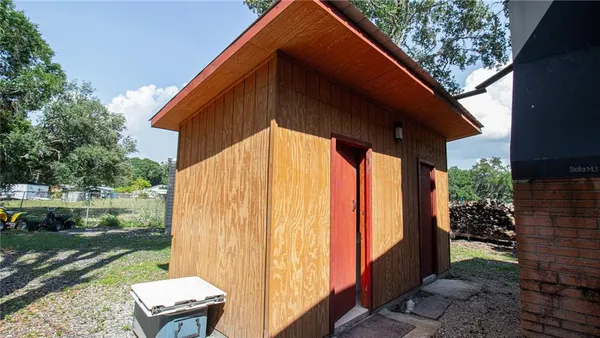 a view of a patio with table and chairs under an umbrella