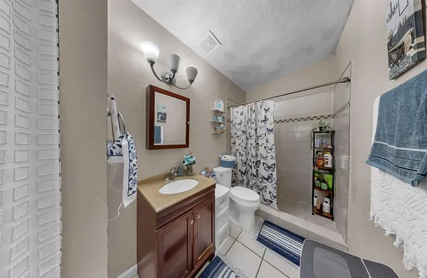 a bathroom with a sink mirror and toilet