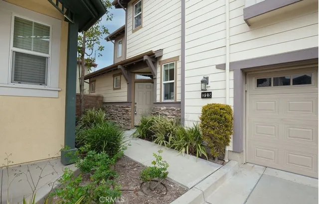 a view of a house with potted plants