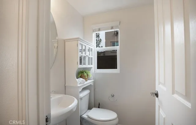 a white toilet sitting next to a bathroom sink