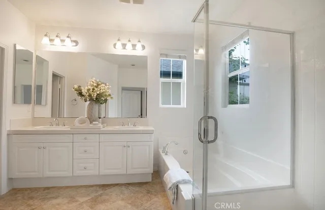 a bathroom with a granite countertop sink a toilet and mirror